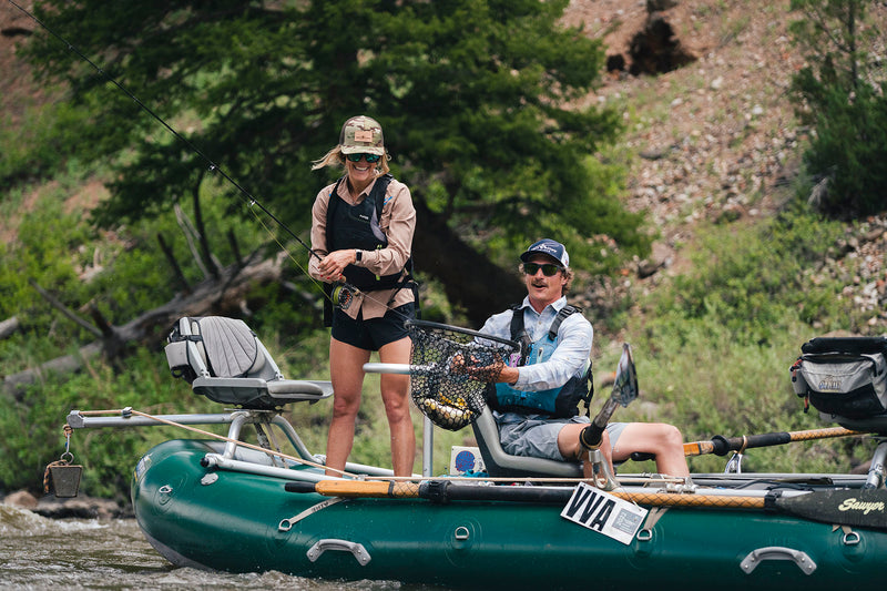 A Vail Valley Anglers guide nets a beautiful brown trout for an angler during a float  on the Colorado River.
