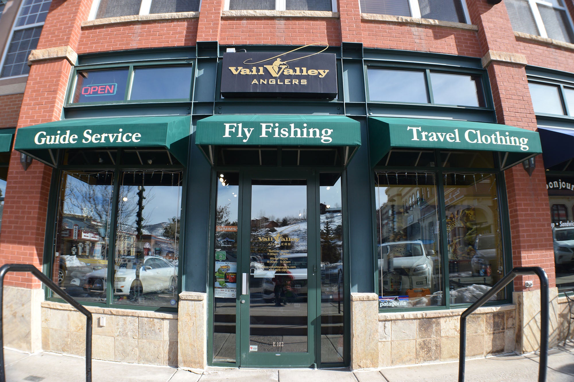 Storefront with 'Valley Valley Anglers' sign and green awnings displaying fly fishing related services.